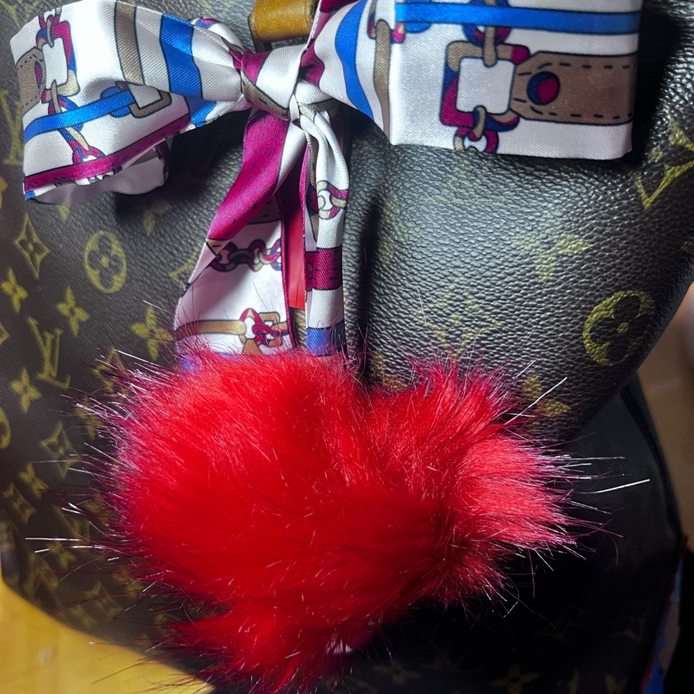 Bag ribbon and fur ball accessory. (Fashion)